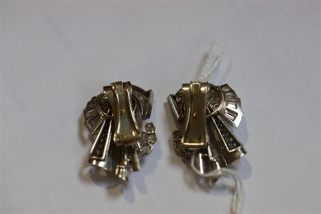 A pair of diamond and synthetic? sapphire clips in white metal settings (tests as platinum), white metal fitments